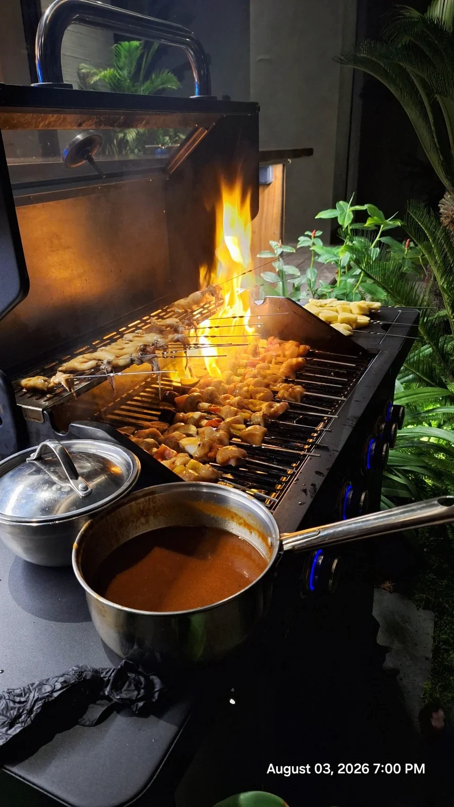 Food cooking on a grill with flames rising above it