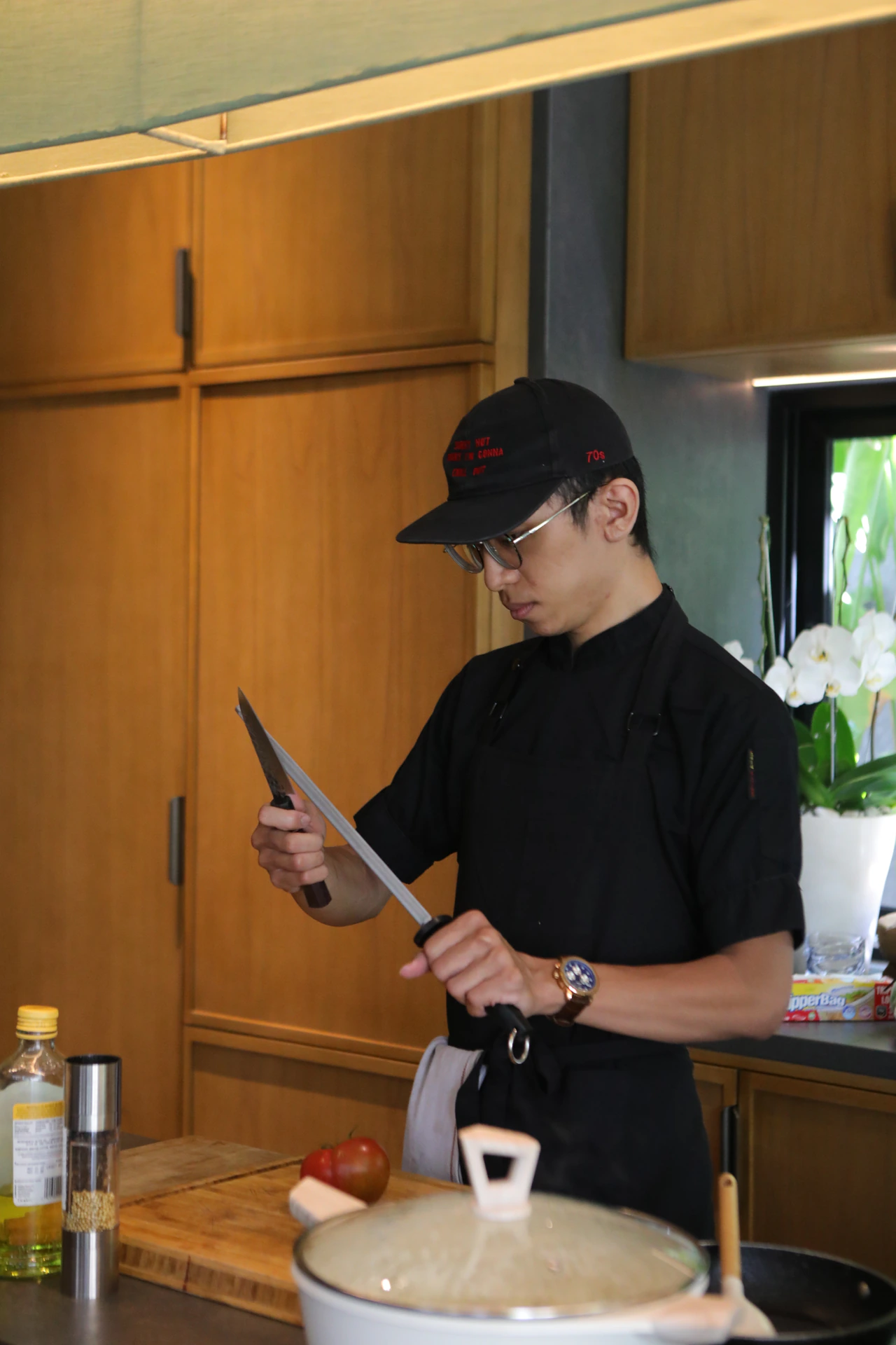 A chef sharpening a kitchen knife before cooking